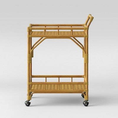 A fine round frame with slender metal rods supports a tabletop made of white coloured safety glass. Cassia Rattan Bar Cart - Opalhouse™ | Rattan bar cart ...