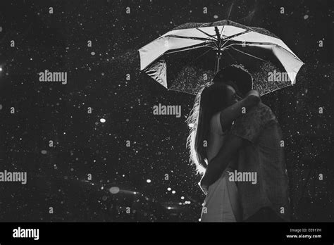 Love In The Rain Silhouette Of Kissing Couple Under Umbrella Stock