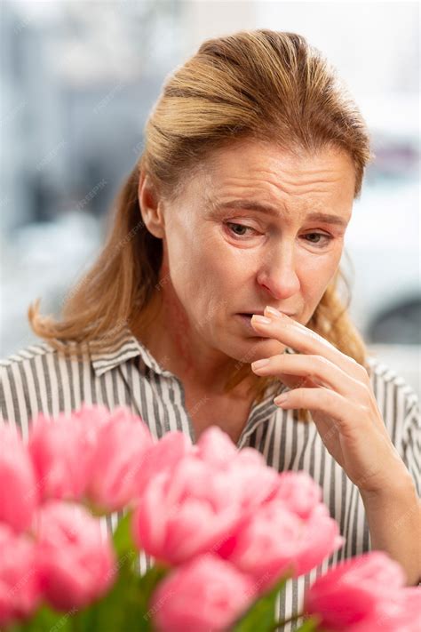 Premium Photo Blond Haired Mature Woman Feeling Allergic After Receiving Flowers From Husband