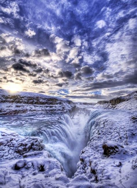 An Image Of A Frozen Waterfall In The Middle Of Winter With Blue Skies