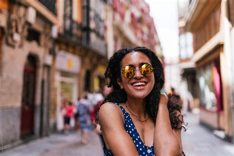 Cheerful Curly Hair Woman With Sunglasses By Stocksy Contributor