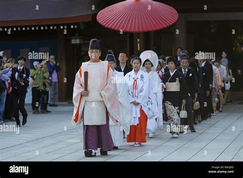 Shinto Wedding Procession With Bride Wearing The Traditional Watabōshi