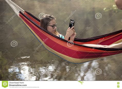 Girl In A Hammock With A Phone In His Hand Stock Photo Image Of White
