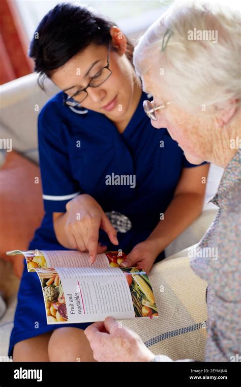 District Nurse Visiting Elderly Woman At Her Home Stock Photo Alamy