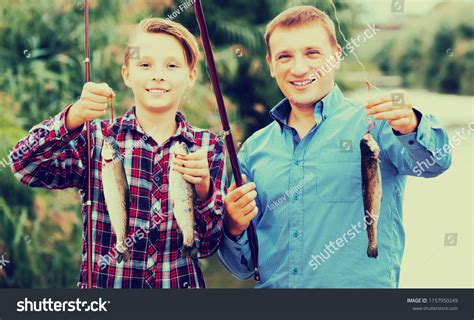 Cheerful Teenage Boy His Father Holding Stock Photo 1157950249