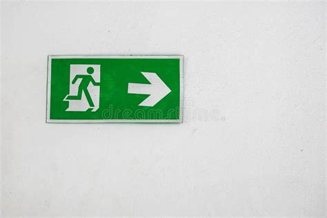 Old Warning Plastic Fire Exit Sign On The White Wall Stock Photo