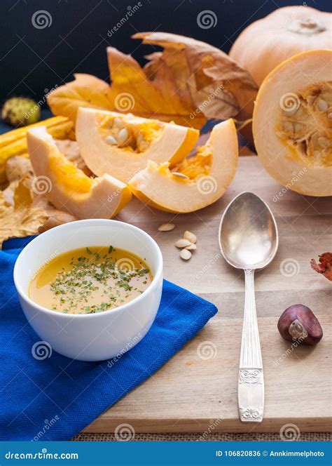 Pumpkin Cream Soup With A Vintage Spoon On A Wooden Board With Stock