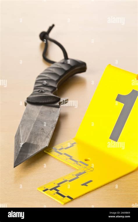 Crime Scene Investigation Csi Evidence Marker With Knife On Wooden