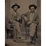 OLD WEST ANTIQUE TINTYPE PHOTO SEATED YOUNG MEN COWBOYS W/ WESTERN 