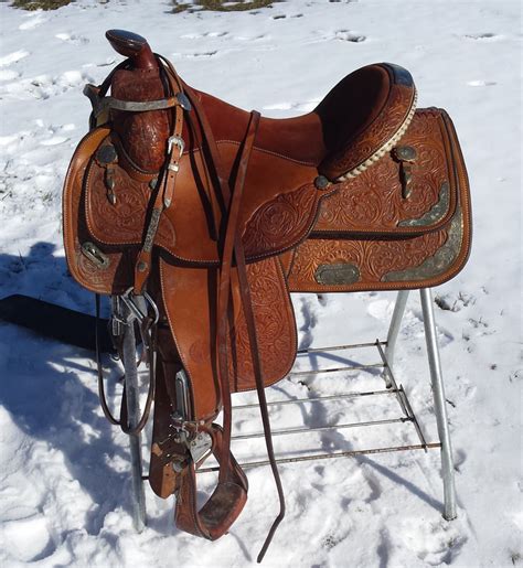 This saddle features smooth leather skirts accented with a floral tooled design in the corner. Saddles For Sale - BILYEA HORSE SALES_ Nelson & Kathy Bilyea
