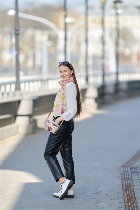 Cheerful Woman Walking On The Bridge And Turning Back Stock Photo