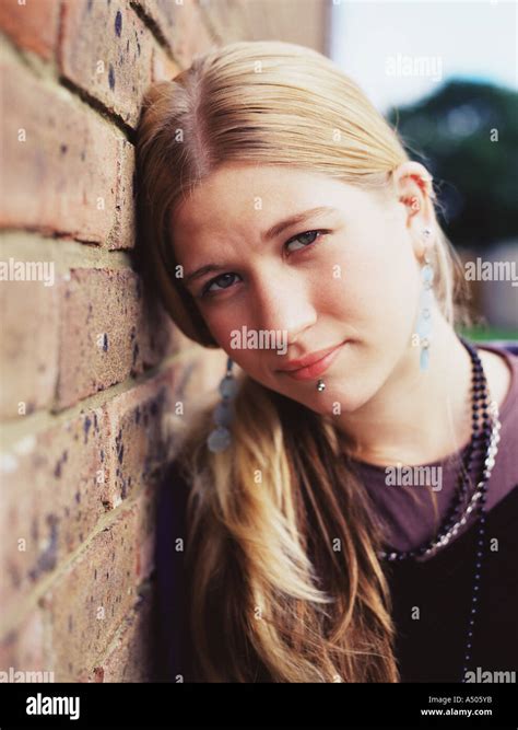 Girl Leaning Against A Wall Stock Photo Alamy