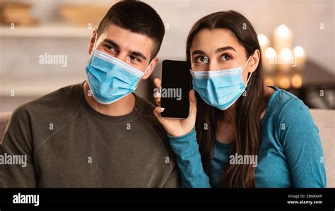 Couple Wearing Surgical Mask Using Smart Phone Stock Photo Alamy