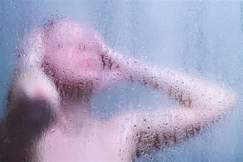 Premium Photo Beautiful Woman In The Shower Behind Glass With Drops