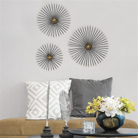 Large blooming flower encompassed by a circle in the center when the three panels are hung next to each other; Best 20+ of Starburst Wall Decor