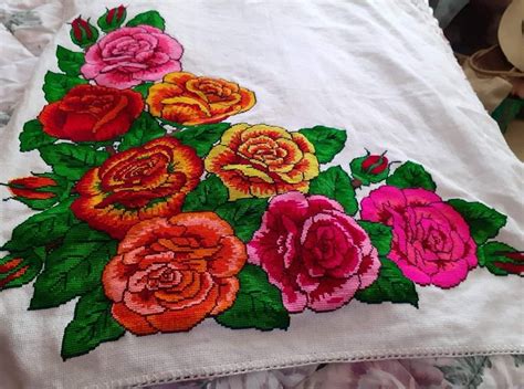 An Embroidered Piece Of Cloth With Flowers On It