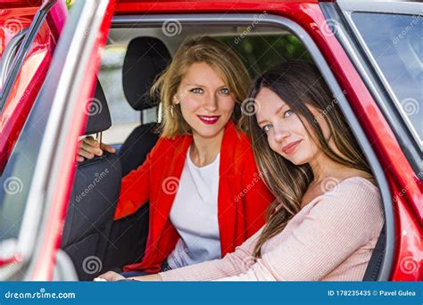 Girls In Back Seat Of Car Looking Out Open Door Stock Image Image Of