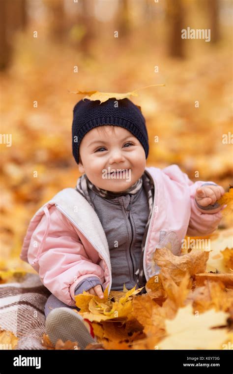Little Girl In The Autumn Park Stock Photo Alamy