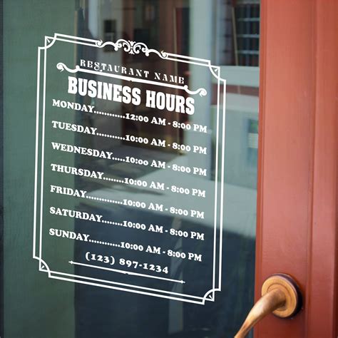 A Business Hours Sign Is Posted On The Glass Door Of A Restaurant With