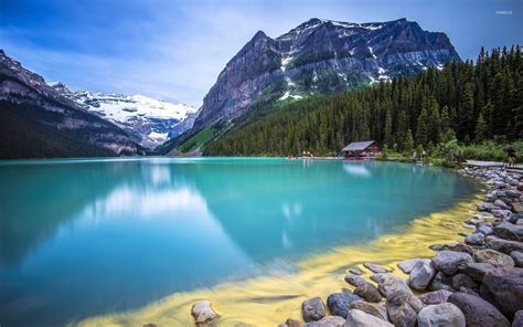 Amazing Turquoise Water Lake Guarded By Rocky Mountains Wallpaper