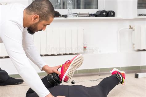 Personal Trainer Instructing Woman At Gym Stock Photo Image Of