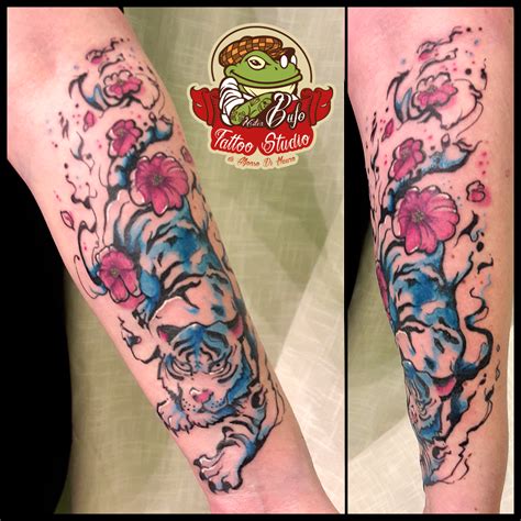 In a watercolor tiger tattoo, your artist will use light washes of color to create a piece that has a sense of artistry and movement. Sakura watercolor tiger tattoo for a sweet mother #tattoo ...