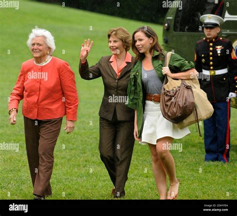 First Lady Laura Bush Waves To Onlookers As She Walks With Former First
