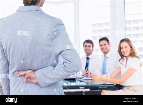 Composite Image Of Businesswoman With Fingers Crossed Behind Her Back