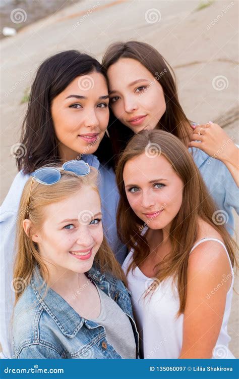 Smiling Group Of Female Students In Summer Clothes Posing Together