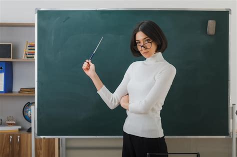 Premium Photo Strict Young Female Teacher Wearing Glasses Standing In