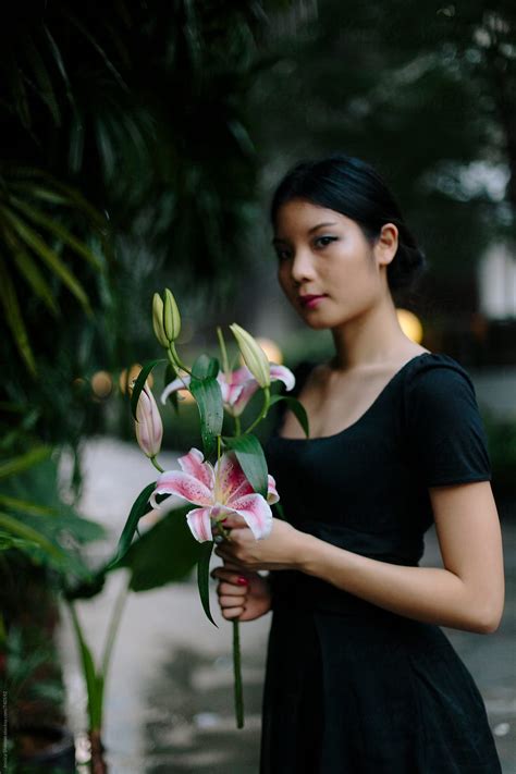 Portrait Of Beautiful Chinese Woman Holding Flowers By Jessica Lia