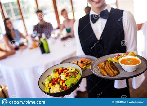 Waitress Holding Food On Plate In Restaurant Stock Photo Image Of