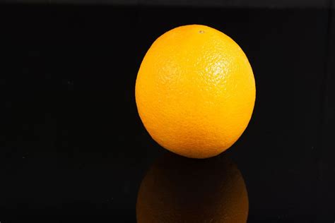 Whole Orange Fruit Above Reflective Black Background Flip 2019