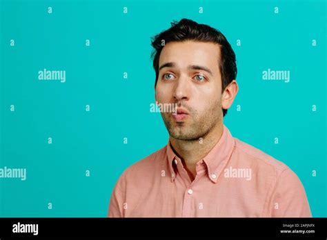 Portrait Of A Young Adult Man Making Funny Faces Isolated On Blue