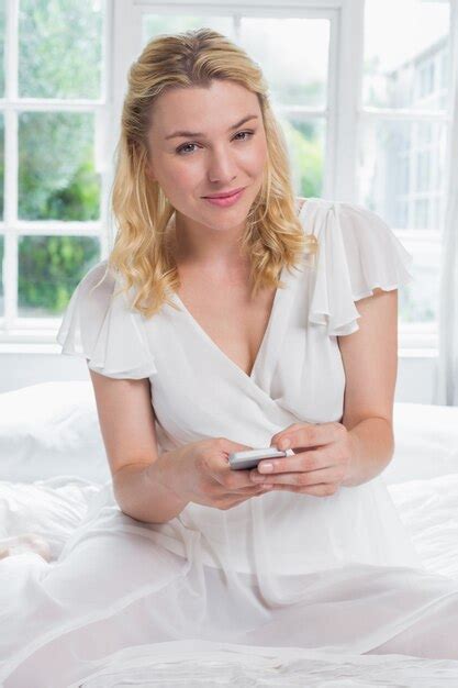 Premium Photo Pretty Blonde Sitting On Bed On The Phone