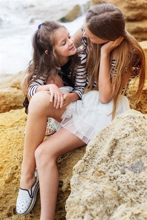 Two Little Sister Girls Sitting On The Beach Stock Image Image Of