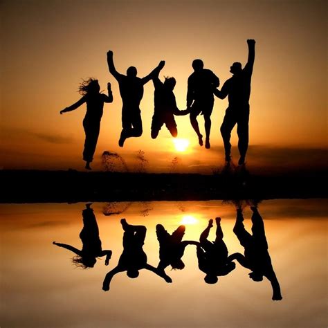 Silhouette Photo Of A Group Of Friends Jumping In The Air At The Beach
