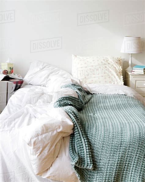 Messy Bed In Bedroom Stock Photo Dissolve