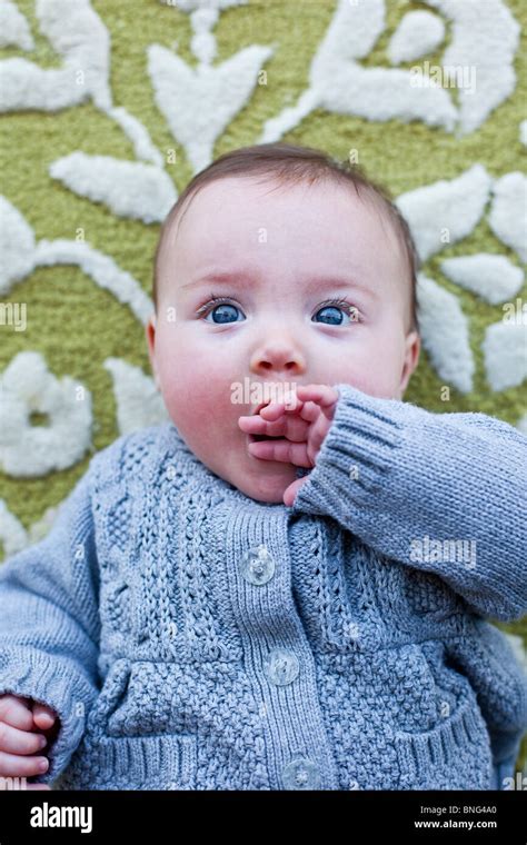 Close Up Of A Baby Girl Lying On A Rug Stock Photo Alamy