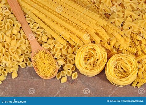 Assortment Of Uncooked Italian Pasta On A Wooden Background Stock Photo
