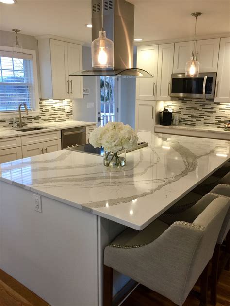 White gives better results when combined with another white while designing the new kitchen. White shaker kitchen cabinets with white and gray Quartz from Cambria Brittanicca. | Kitchen ...
