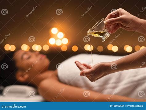 Therapist Applying Massage Oil On Hands Before Therapy Stock Image