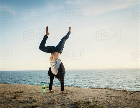 Man Doing Handstand On Beach Stock Photo Dissolve