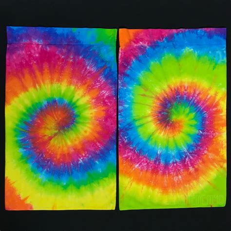 Two Square Shaped Tie Dyed Pictures On Black Paper