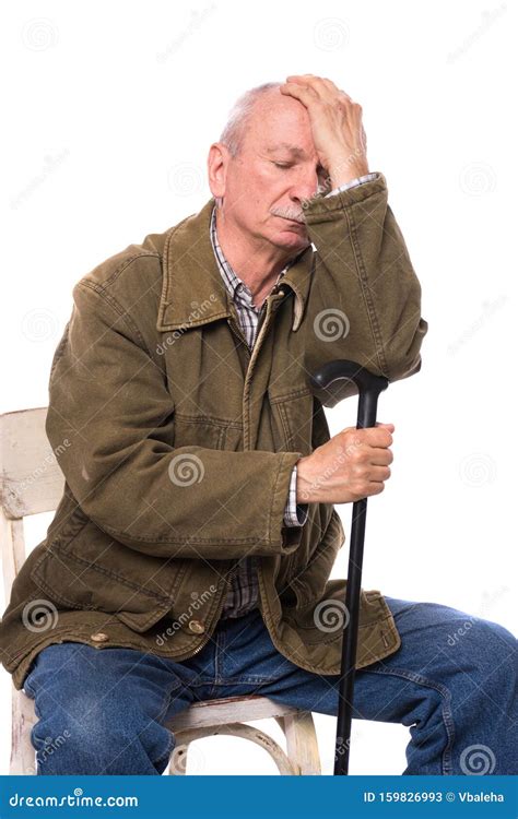 Sad Lonely Elderly Man With A Cane Sitting On A Chair Stock Image