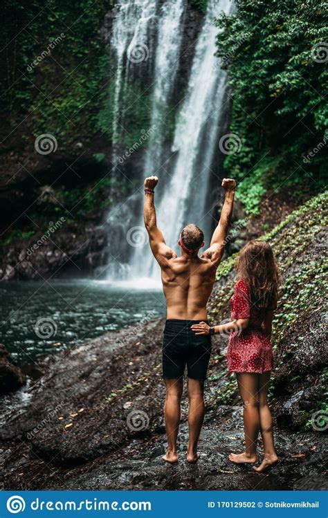 Tourists At The Waterfall Rear View Couple On Vacation In Bali Honeymoon Trip A Couple In