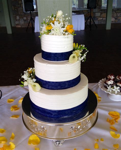 Simple Buttercream Wedding Cake With Navy Blue Ribbon And Fresh Flowers