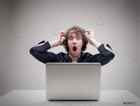 Shocked Man In Front Of His Computer Stock Photo Crushpixel