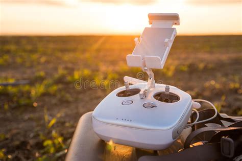 Drone With Digital Camera Flying In Sky Over Field On Sunset Stock