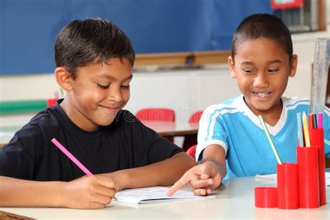Two Schoolboys Helping Each Other Learn In Class D Stock Image Image